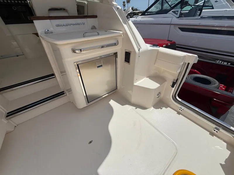 Slide: The Image of The image shows the cockpit of a 2026 Grady-White Express 340 with a small kitchenette. - 11