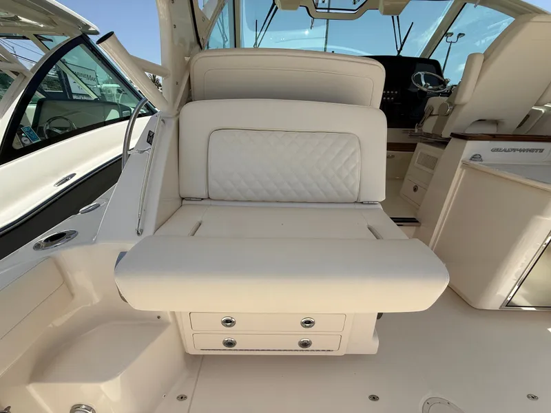Slide: The Image of The image shows the interior of a Grady-White Express 340 boat with beige upholstery and helm console. - 16