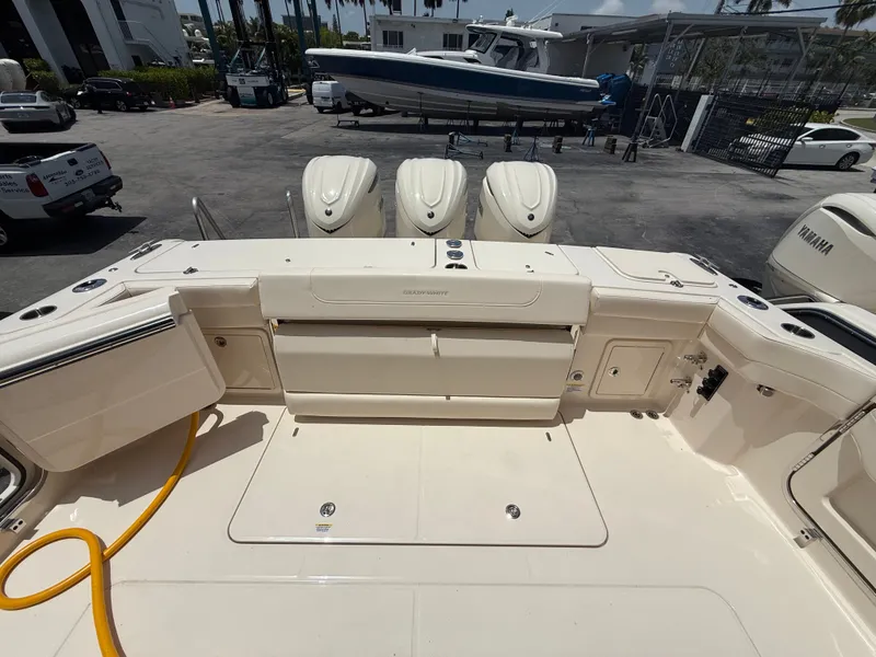 Slide: The Image of The image shows the spacious aft deck of a Grady-White Express 340 with three outboard engines. - 10