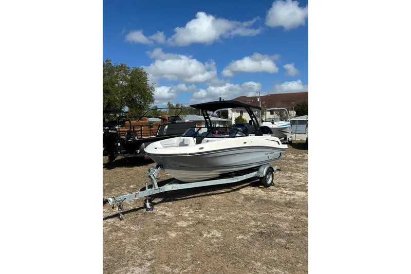 Slide: The Image of 2025 Bayliner VR5 Bowrider OB on trailer under blue sky. - 21