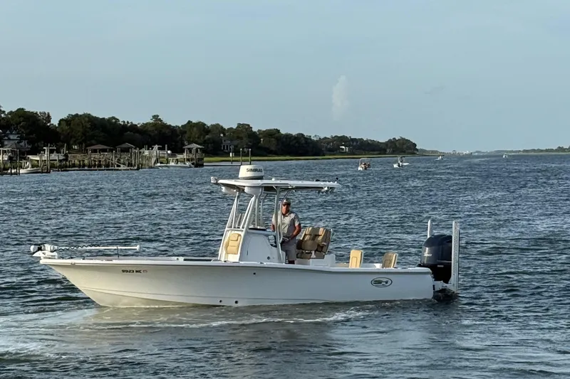 Slide: The Image of 2017 Sea Hunt BX 25 BR boat cruising on a scenic waterway. - 13