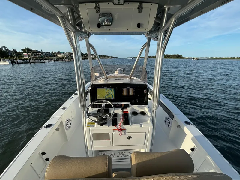 Slide: The Image of 2017 Sea Hunt BX 25 BR boat interior with navigation system, steering wheel, and open water view. - 6