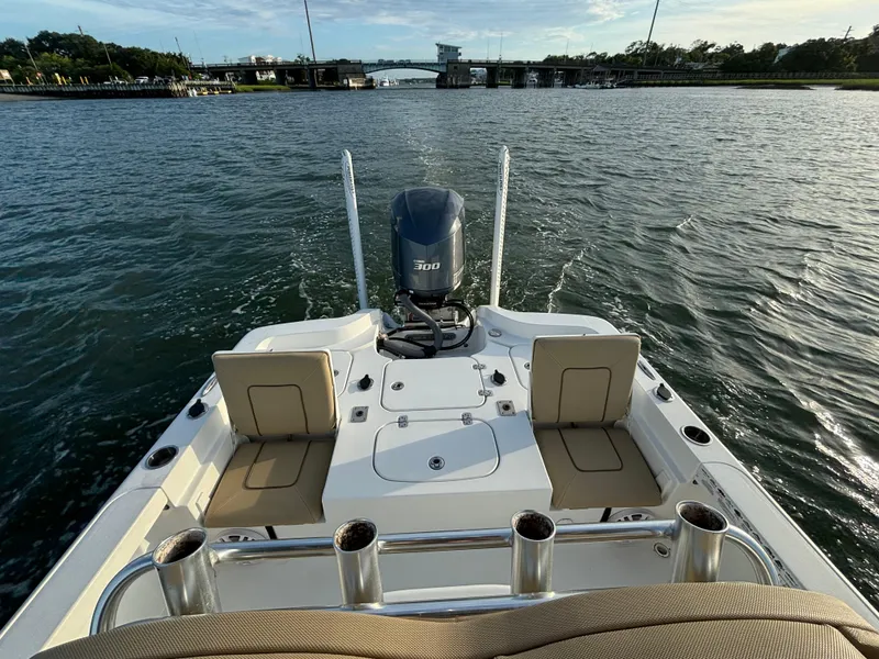 Slide: The Image of 2017 Sea Hunt BX 25 BR boat on water, rear view with motor and seating. - 8