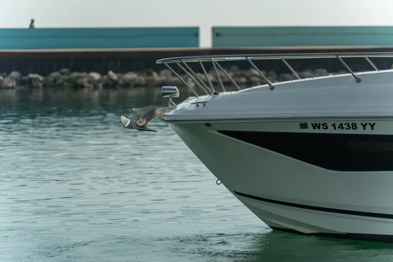 Slide: The Image of 2019 Sea Ray Sundancer 320 boat anchored in calm waters, featuring a visible anchor. - 17