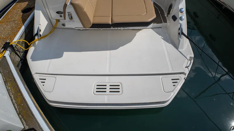 Slide: The Image of 2019 Sea Ray Sundancer 320 swim platform with tan seating, docked at marina. - 38
