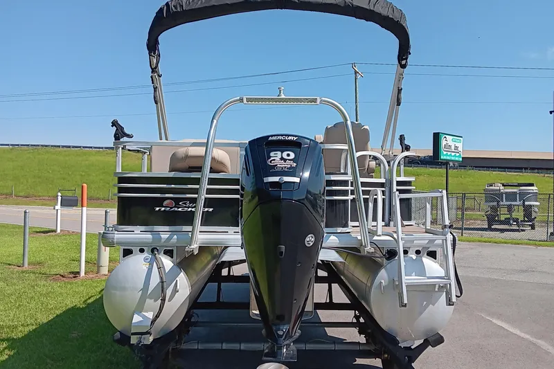 Slide: The Image of 2021 Sun Tracker Fishin' Barge 20 DLX pontoon boat with Mercury engine, parked outdoors. - 3
