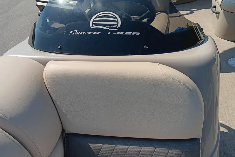 Slide: The Image of 2021 Sun Tracker Fishin' Barge 20 DLX boat interior with beige seating and windshield. - 9