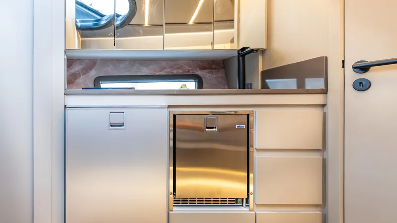 Slide: The Image of Modern kitchen interior in 2025 Hanover 415 RV with stainless steel appliances. - 43