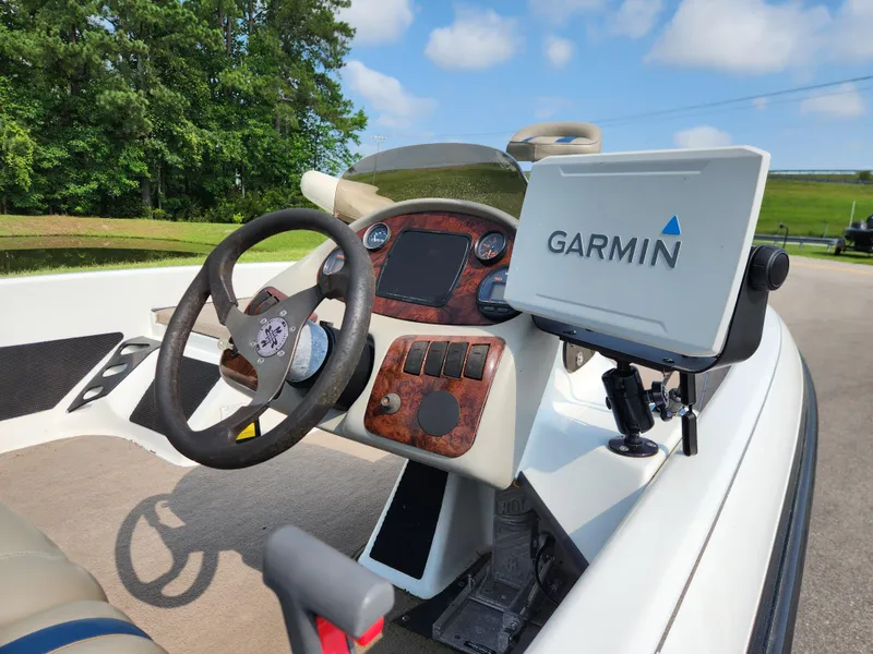 Slide: The Image of 2003 Ranger 195SVS boat dashboard with Garmin GPS, steering wheel, and control panel. - 10