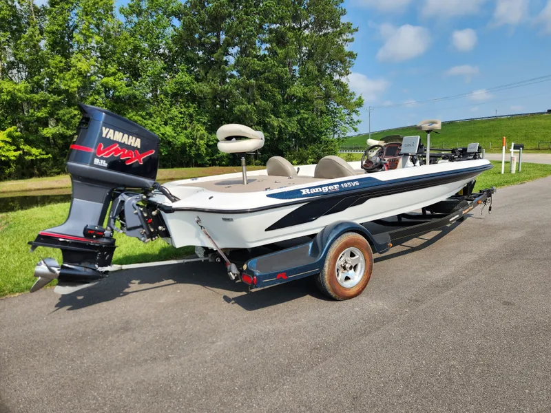 Slide: The Image of 2003 Ranger 195SVS boat with Yamaha VMAX engine on a trailer, parked outdoors. - 2