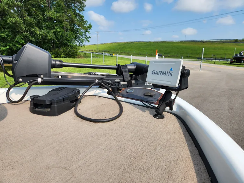 Slide: The Image of 2003 Ranger 195SVS boat with Garmin navigation system on deck, surrounded by greenery. - 9