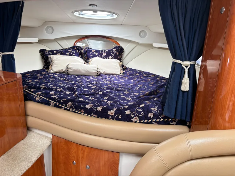 Slide: The Image of Luxurious cabin interior of 2005 Four Winns 328 Vista Cruiser with elegant bedding and wood finish. - 10