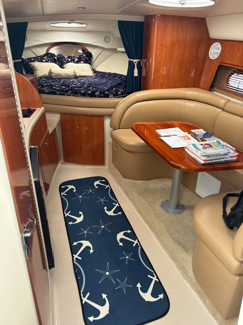 Slide: The Image of 2005 Four Winns 328 Vista Cruiser interior with cozy seating and nautical decor. - 6