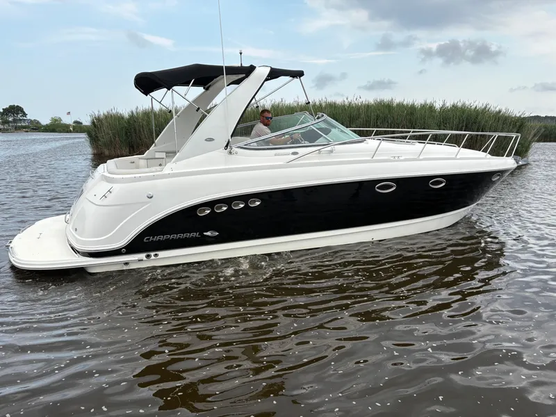 Slide: The Image of 2006 Chaparral Signature 350 boat on calm water under cloudy sky. - 1