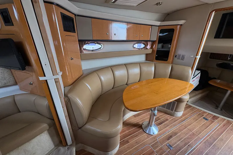 Slide: The Image of 2006 Chaparral Signature 350 boat interior with white seating and table. - 12