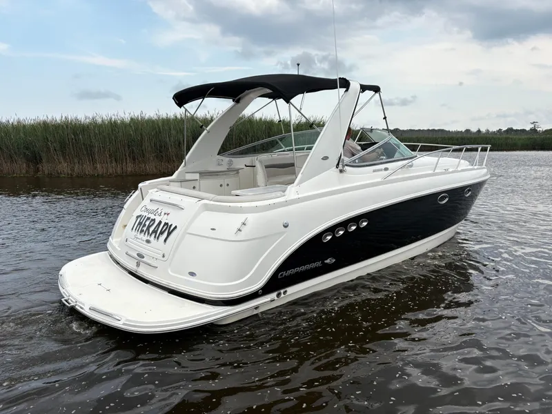 Slide: The Image of 2006 Chaparral Signature 350 boat on calm water under cloudy sky. - 3