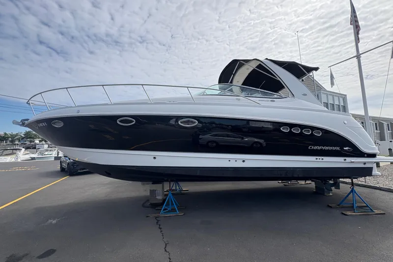 Slide: The Image of 2006 Chaparral Signature 350 boat on water, rear view with canopy, overcast sky. - 4
