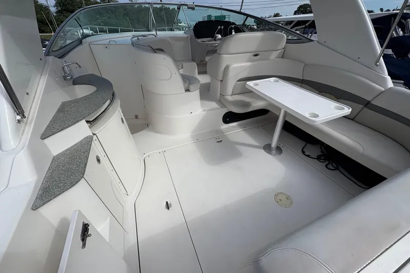 Slide: The Image of 2006 Chaparral Signature 350 boat docked in a marina, featuring sleek design and black hull. - 5