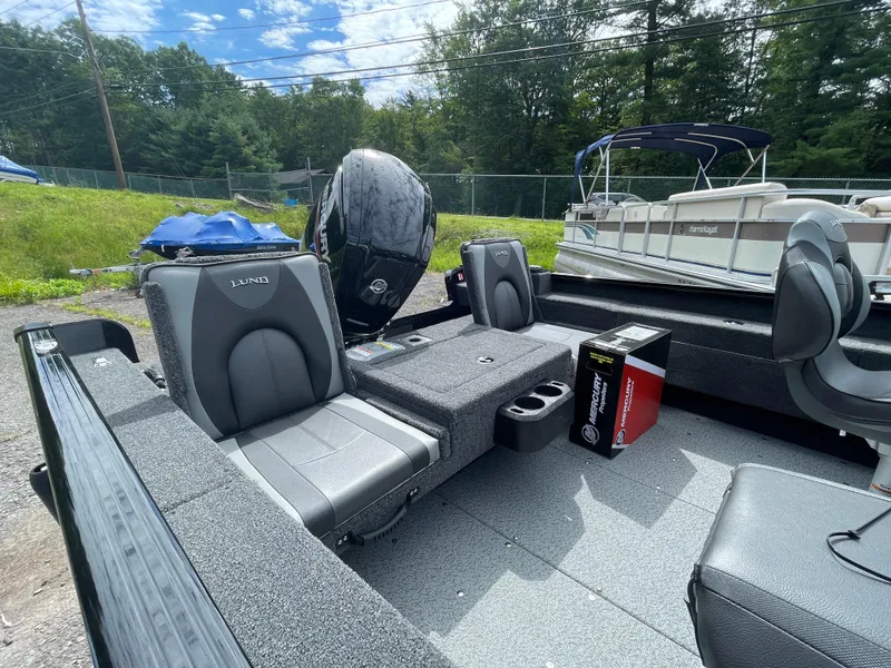 Slide: The Image of 2026 Lund 1675 Adventure Sport boat interior with seating and Mercury engine box. - 5