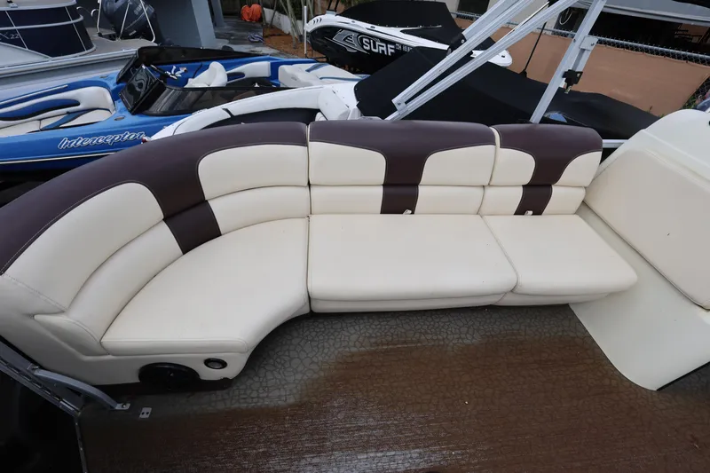 Slide: The Image of Luxurious seating on a 2021 Lexington 525 cc boat, featuring cream and brown upholstery. - 10