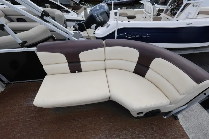 Slide: The Image of Luxurious seating on a 2021 Lexington 525 cc boat, featuring cream and brown upholstery. - 11