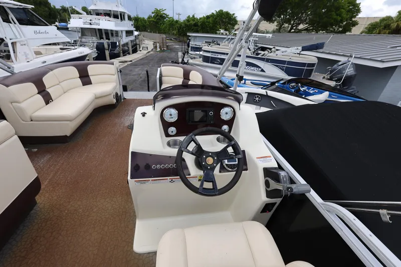 Slide: The Image of 2021 Lexington 525 cc boat interior with steering wheel and seating area. - 14