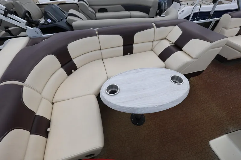 Slide: The Image of Luxurious seating area on 2021 Lexington 525 cc boat with round table and cup holders. - 16