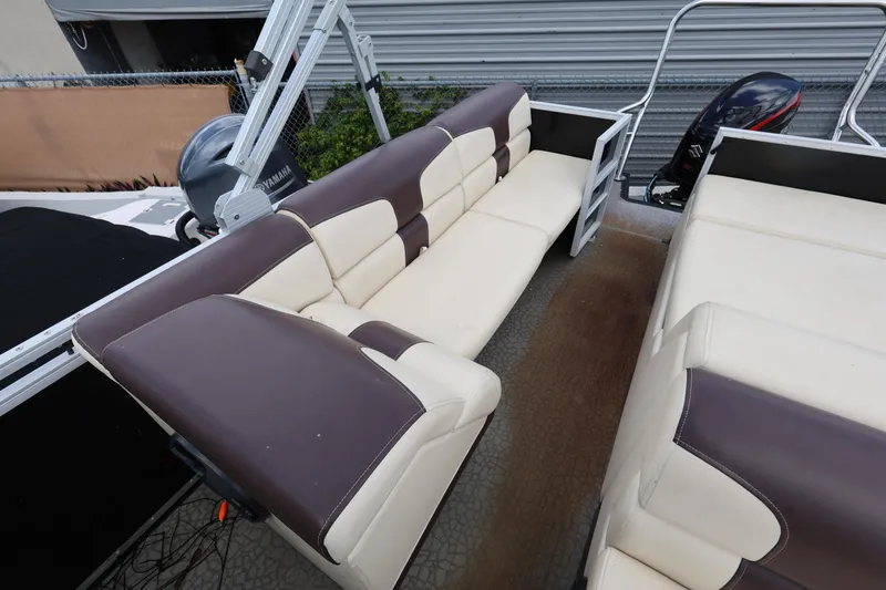 Slide: The Image of 2021 Lexington 525 cc boat interior with beige and brown seating. - 18
