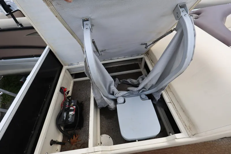 Slide: The Image of 2021 Lexington 525 cc boat with open storage compartment and portable toilet. - 19
