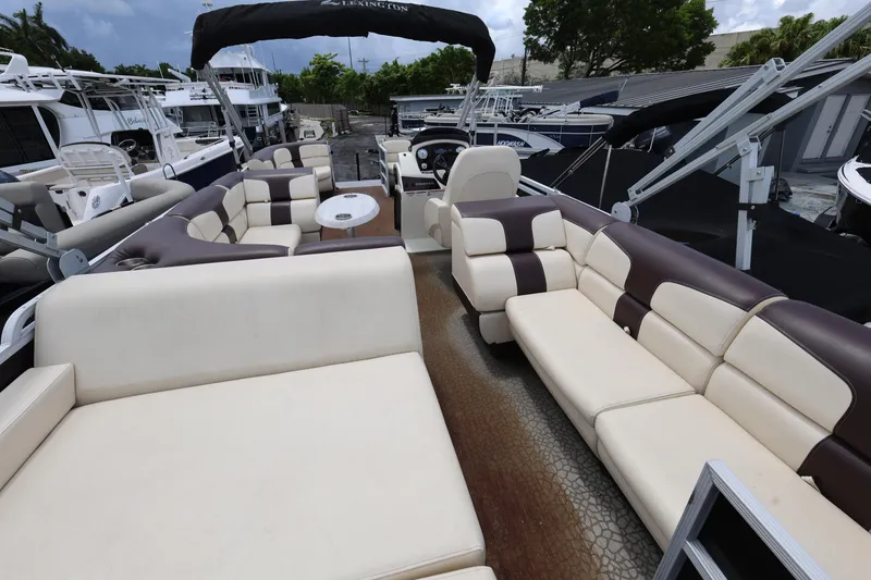 Slide: The Image of Luxurious 2021 Lexington 525 cc pontoon boat with spacious seating and elegant design. - 20