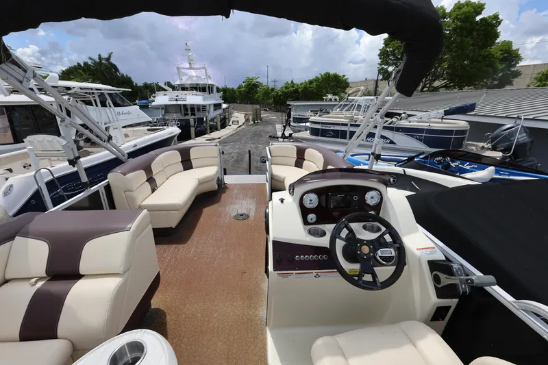 Slide: The Image of Interior view of a 2021 Lexington 525 cc boat with luxurious seating and steering console. - 22