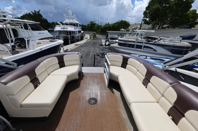 Slide: The Image of Luxurious 2021 Lexington 525 cc boat interior with plush seating, docked among other boats. - 23