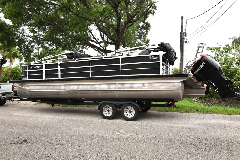 Slide: The Image of 2021 Lexington 525 cc pontoon boat on trailer with Suzuki outboard motor. - 3