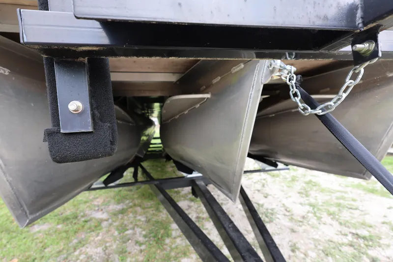 Slide: The Image of Underneath view of a 2021 Lexington 525 cc pontoon boat with metal chains and supports. - 7