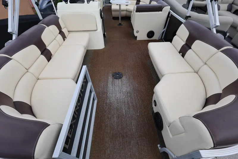 Slide: The Image of Interior of a 2021 Lexington 525 cc boat with beige and brown seating. - 8