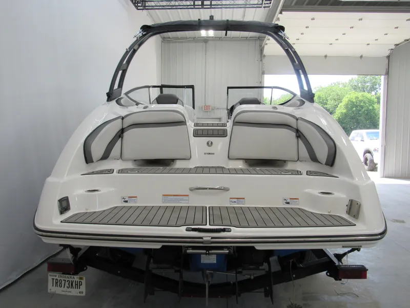 Slide: The Image of 2018 Yamaha Boats AR240, rear view in a garage setting. - 3