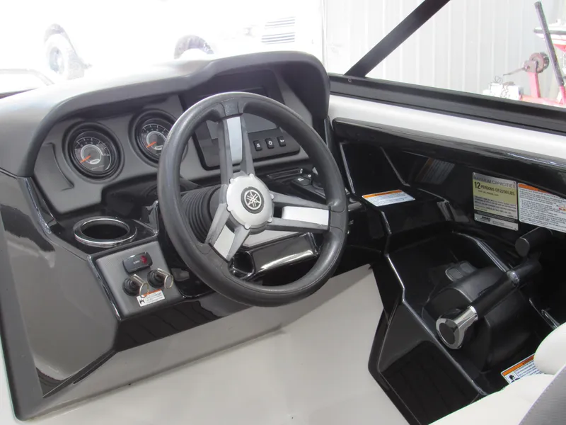 Slide: The Image of 2018 Yamaha AR240 boat dashboard with steering wheel and controls. - 6