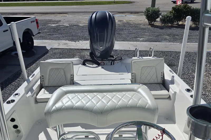 Slide: The Image of 2026 Blazer PureBay 2400 boat interior with diamond-stitched seating and powerful outboard motor. - 12
