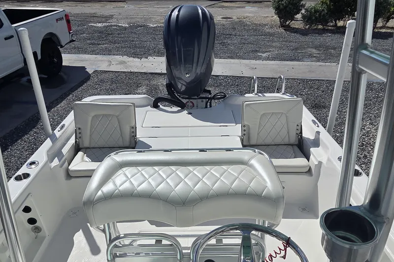 Slide: The Image of 2026 Blazer PureBay 2400 boat interior with diamond-stitched seating and outboard motor. - 17