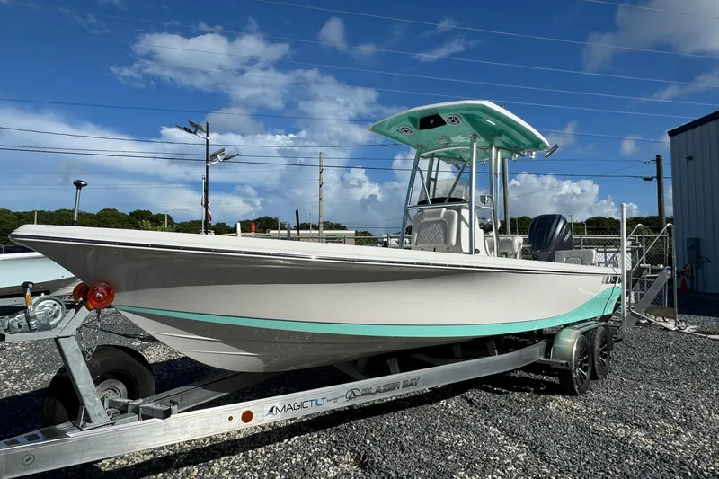 Slide: The Image of 2026 Blazer PureBay 2400 boat on trailer under clear blue sky. - 3