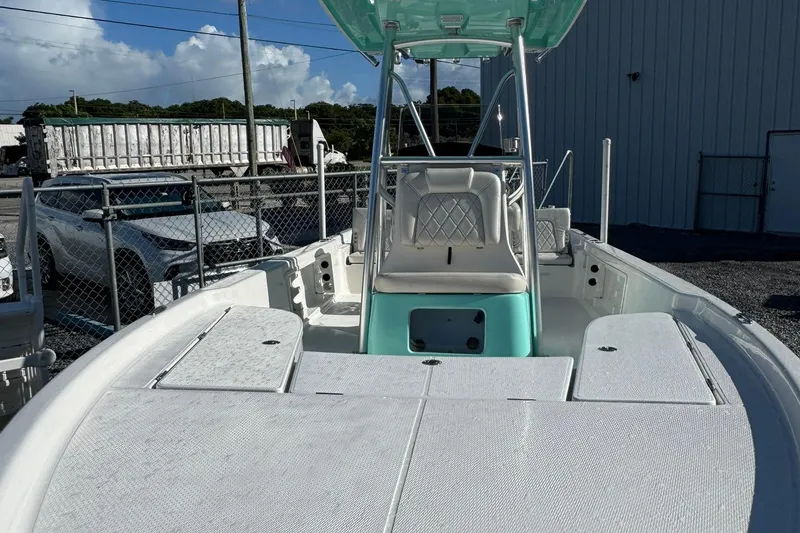 Slide: The Image of 2026 Blazer PureBay 2400 boat with teal accents, docked outdoors. - 4