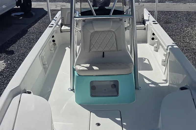 Slide: The Image of 2026 Blazer PureBay 2400 boat interior with white seating and teal accents. - 8