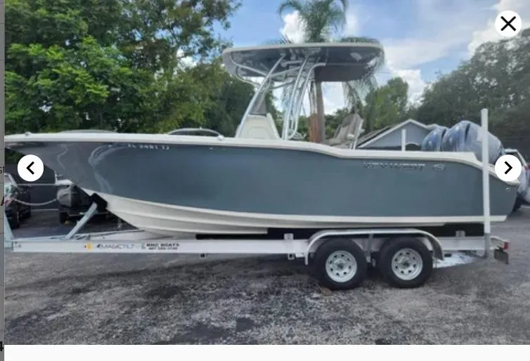 Slide: The Image of 2023 Key West 244 CC boat on trailer, parked outdoors. - 1