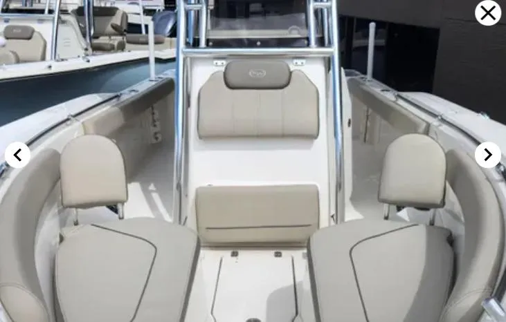 Slide: The Image of 2023 Key West 244 CC boat interior with beige seating and modern design. - 12