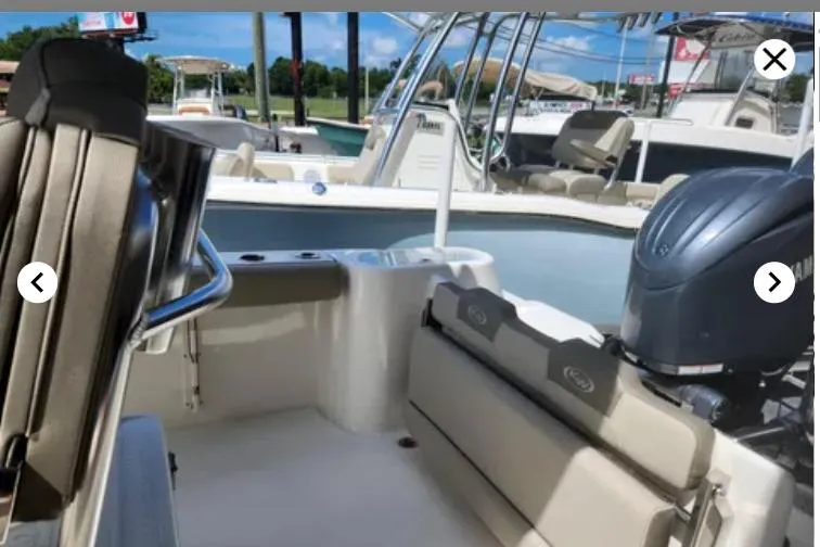 Slide: The Image of 2023 Key West 244 CC boat interior with seating and Yamaha outboard motor. - 4