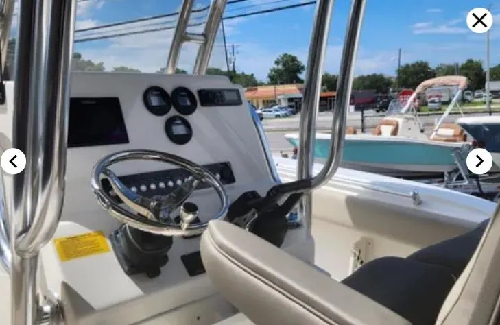 Slide: The Image of 2023 Key West 244 CC boat dashboard with steering wheel and controls. - 6