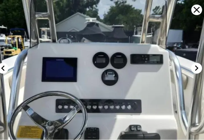 Slide: The Image of 2023 Key West 244 CC boat dashboard with steering wheel and control panel. - 7