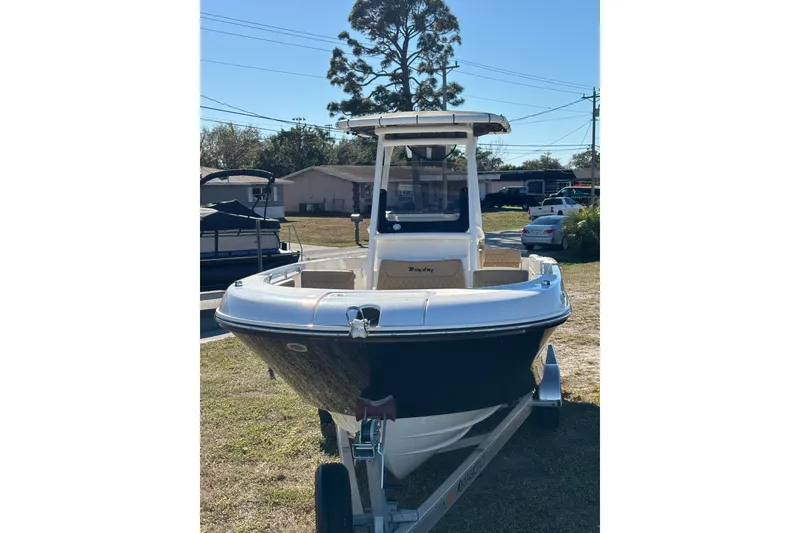 Slide: The Image of 2025 Bayliner Trophy T24CC boat interior with T-top and rod holders. - 10