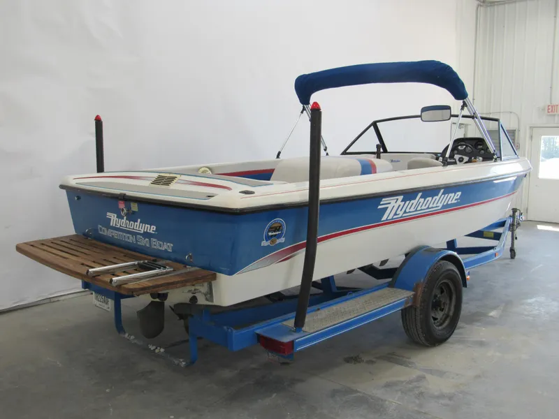 Slide: The Image of 1993 Hydrodyne Comp ski boat with blue and white design on trailer. - 2