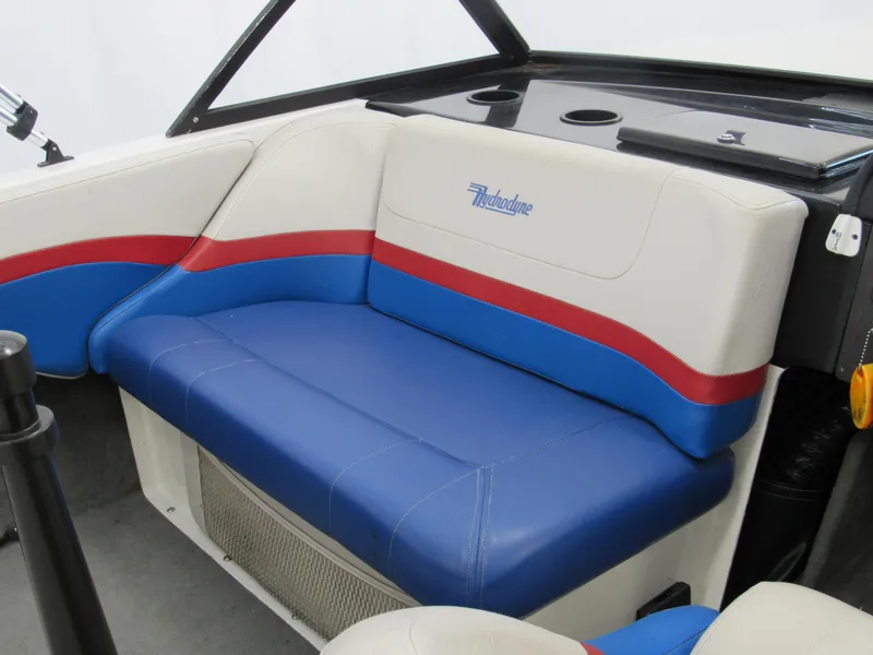 Slide: The Image of 1993 Hydrodyne Comp boat interior with blue, red, and white seating. - 9